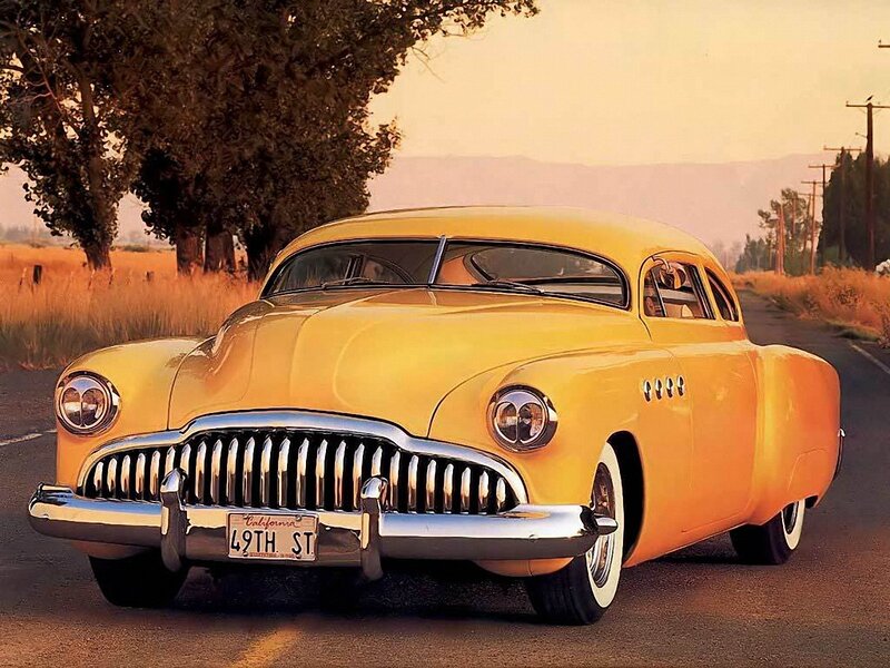 Yellow classic car on a country road