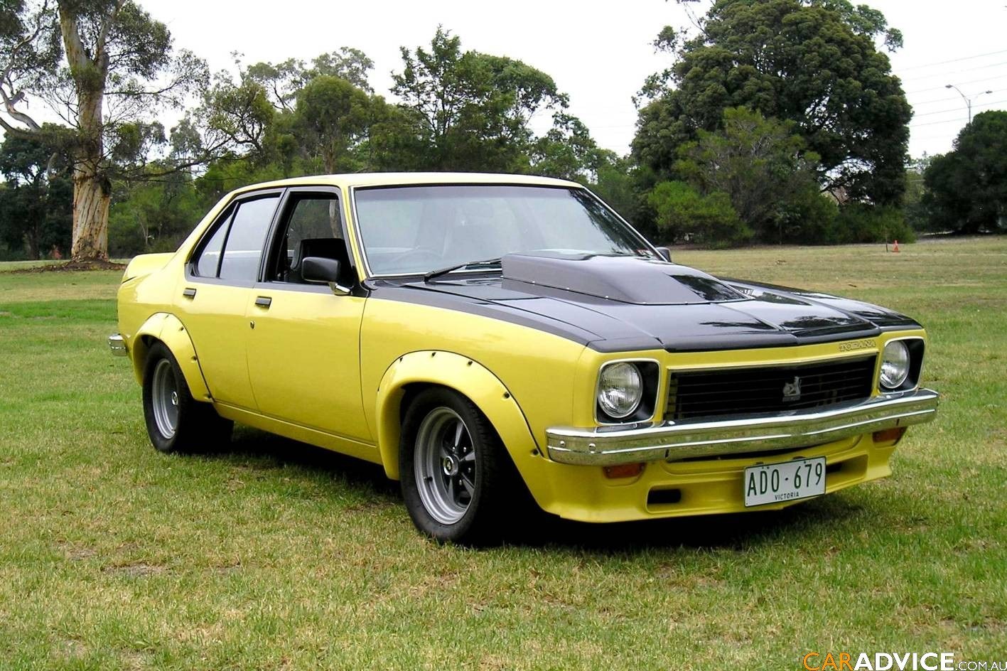 yellow classic car on grass