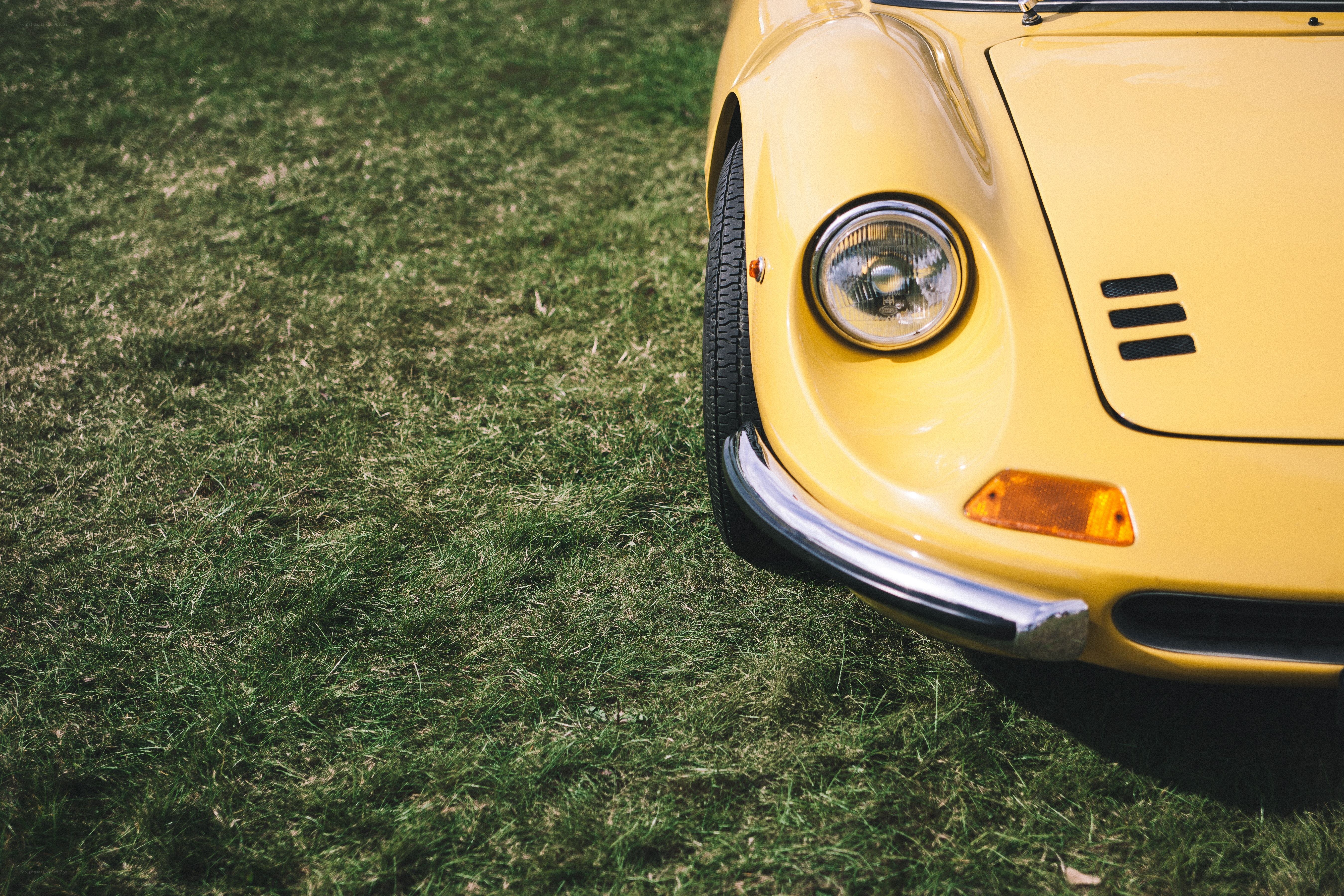 Yellow classic car on grass
