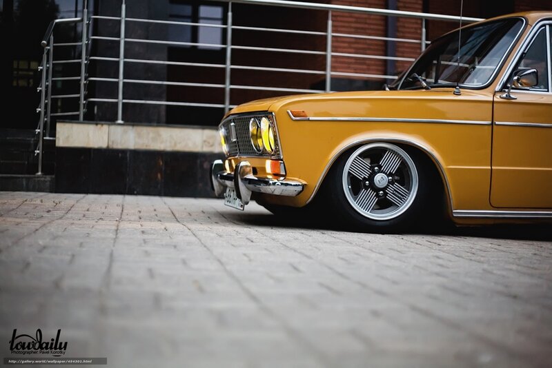 Yellow classic car on pavement