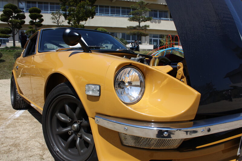 Yellow classic car with open hood