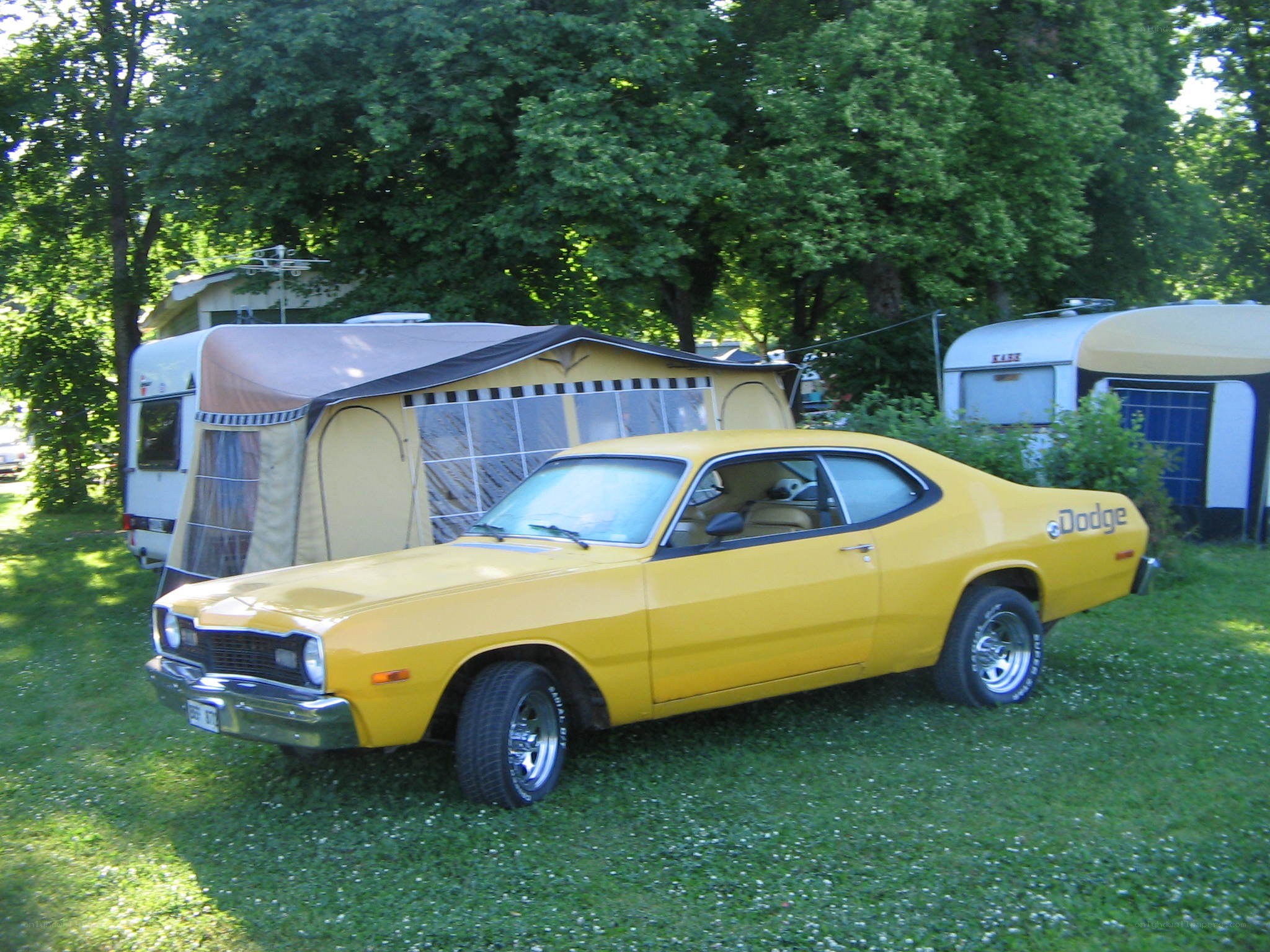 Yellow classic Dodge car at campsite