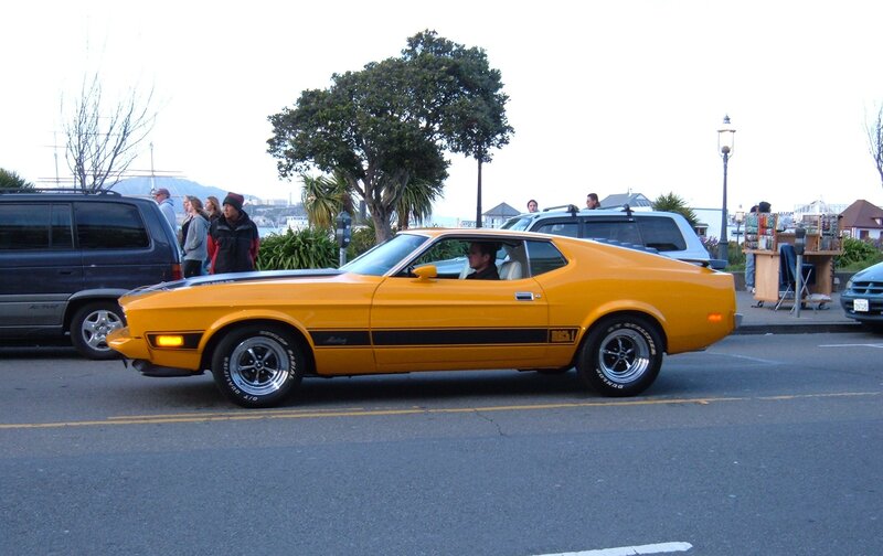 Yellow classic muscle car on street