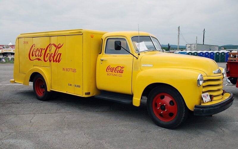 Yellow Coca-Cola delivery truck