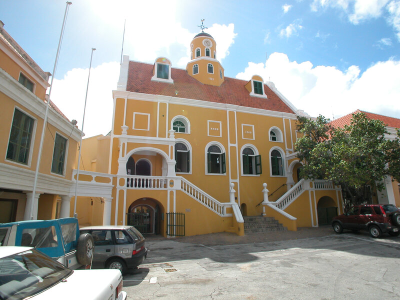 yellow colonial building with clock tower