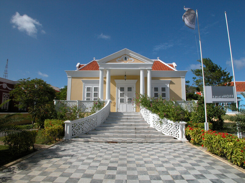 yellow colonial building with steps