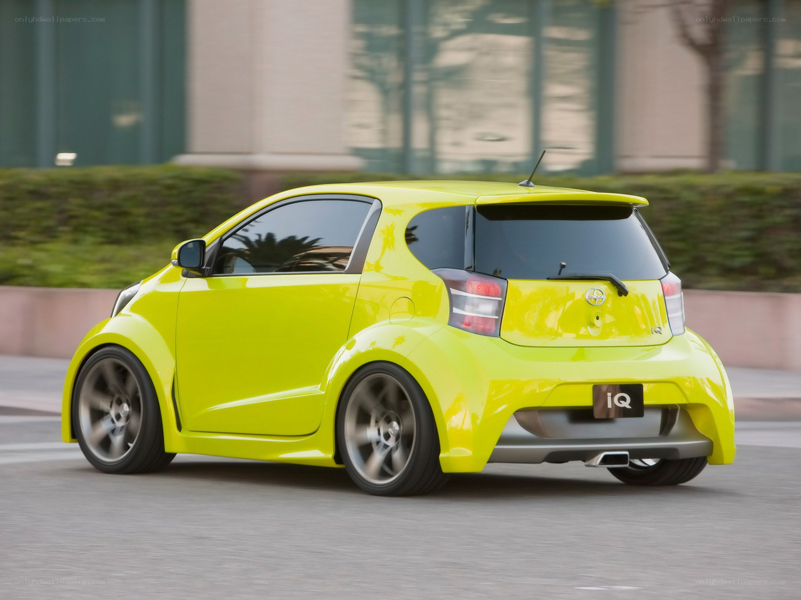 Yellow compact car in motion