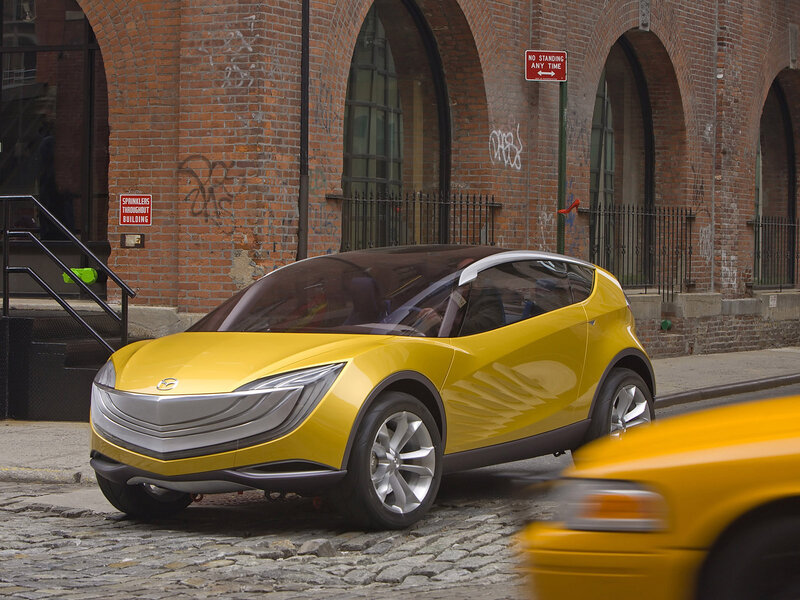 Yellow concept car on cobblestone street