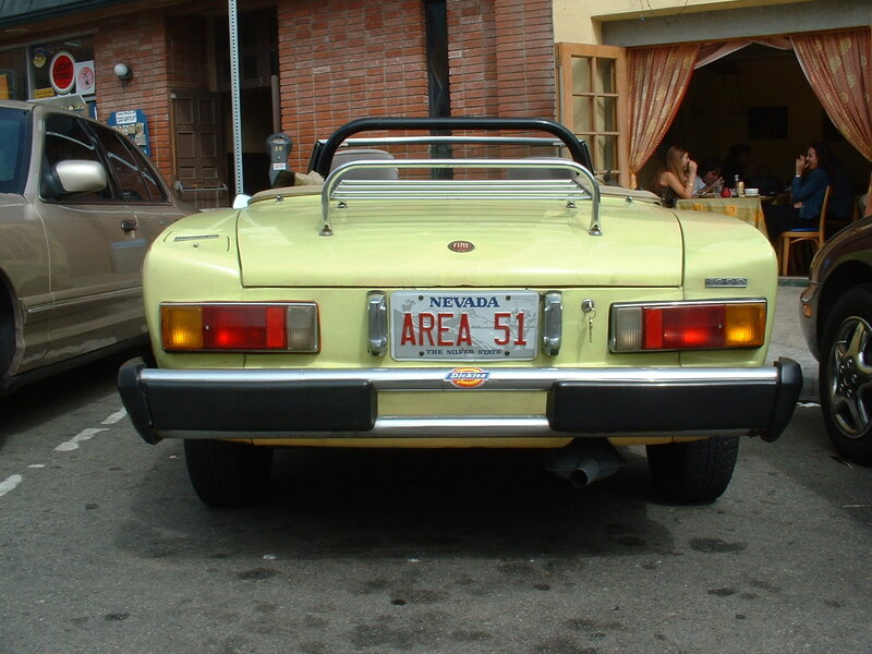 yellow convertible car in parking lot