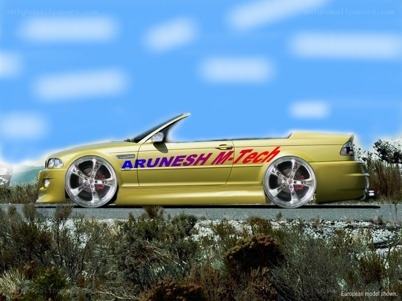 yellow convertible car on road