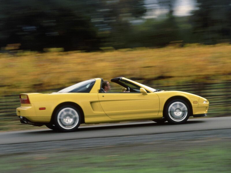 Yellow convertible sports car in motion