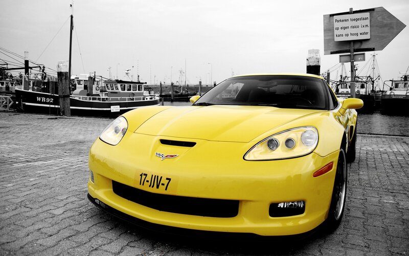 Yellow Corvette at a harbor