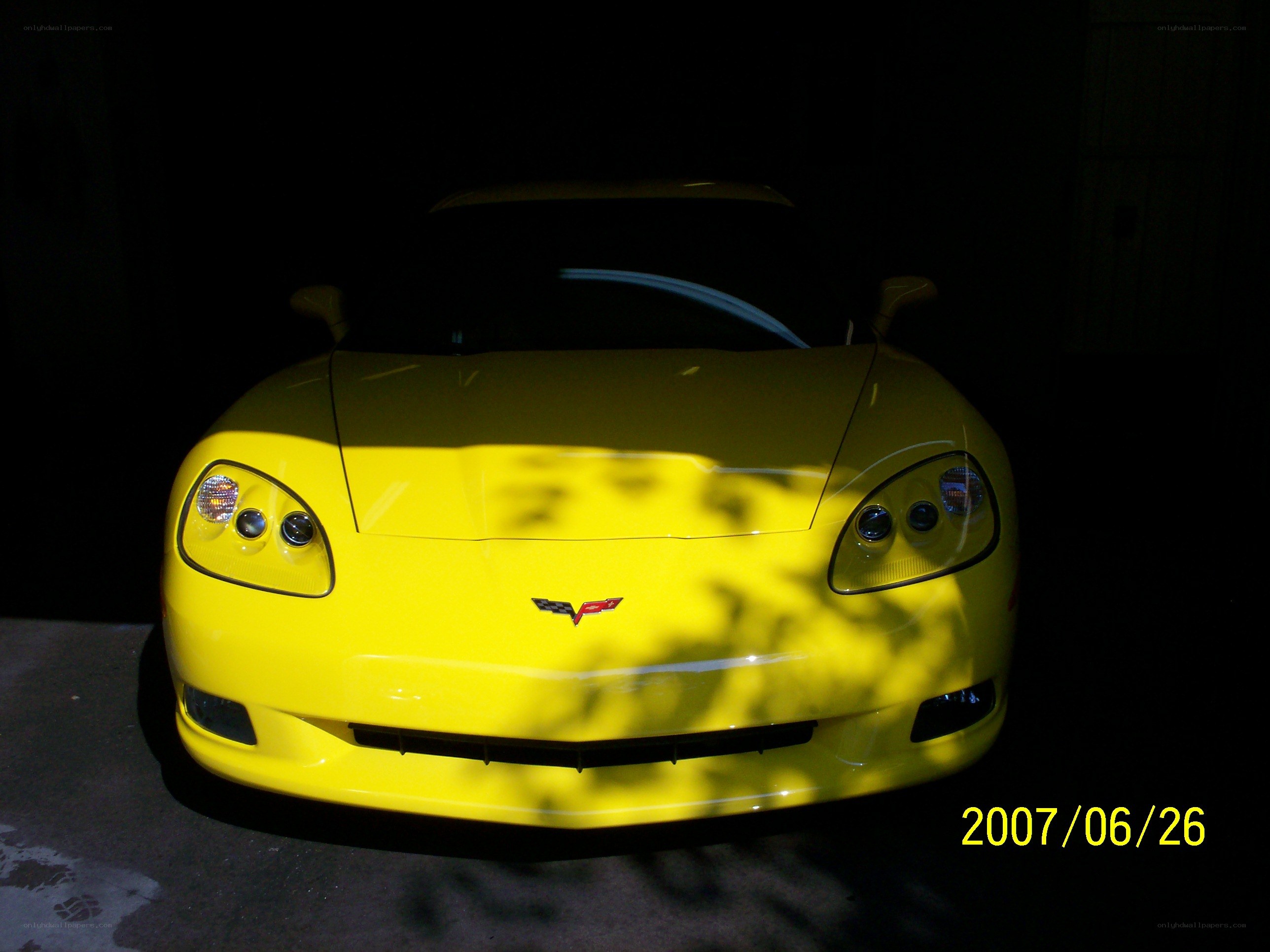 Yellow Corvette in dark garage