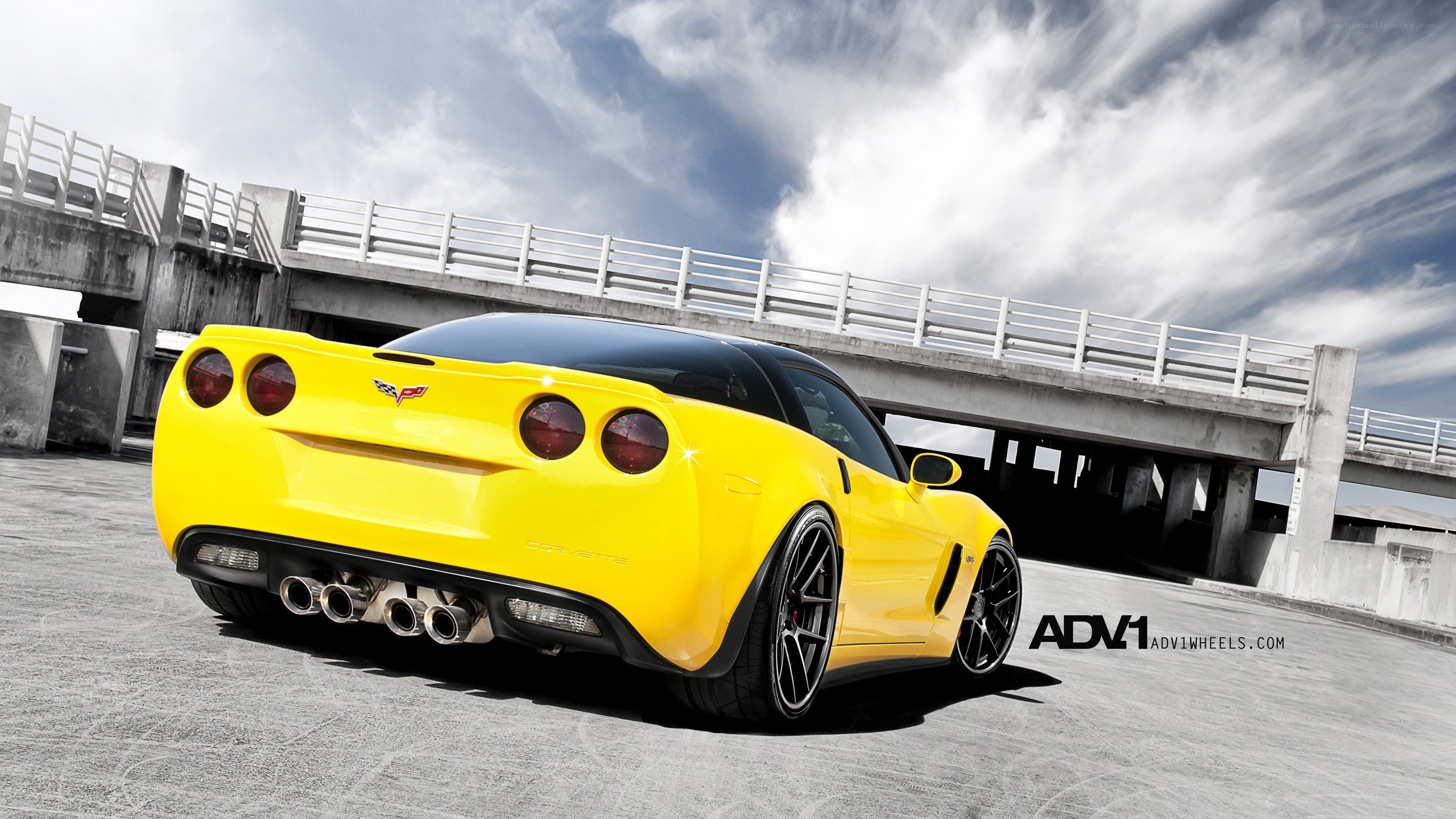 yellow corvette on concrete