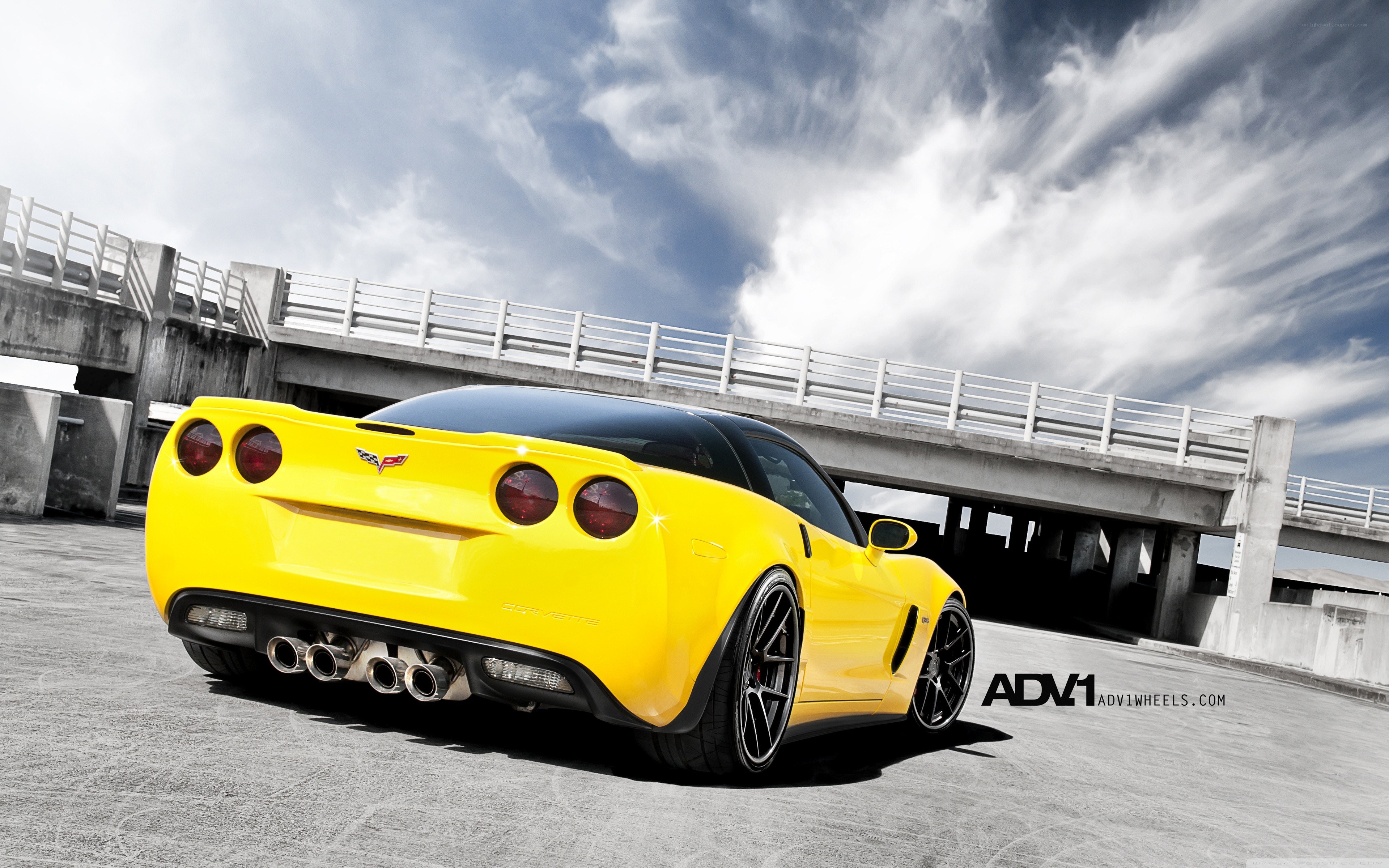yellow corvette on concrete