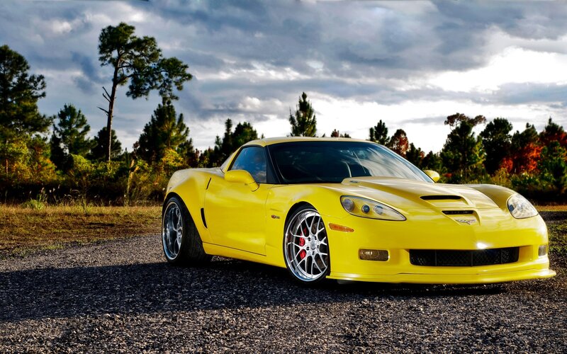 Yellow Corvette on gravel road