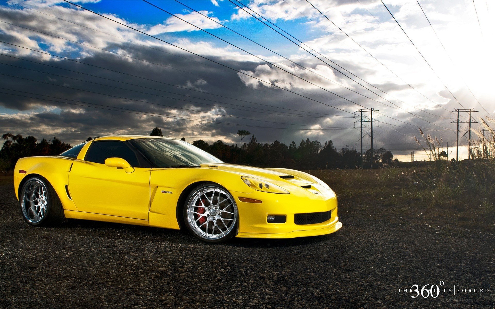 Yellow Corvette on gravel road