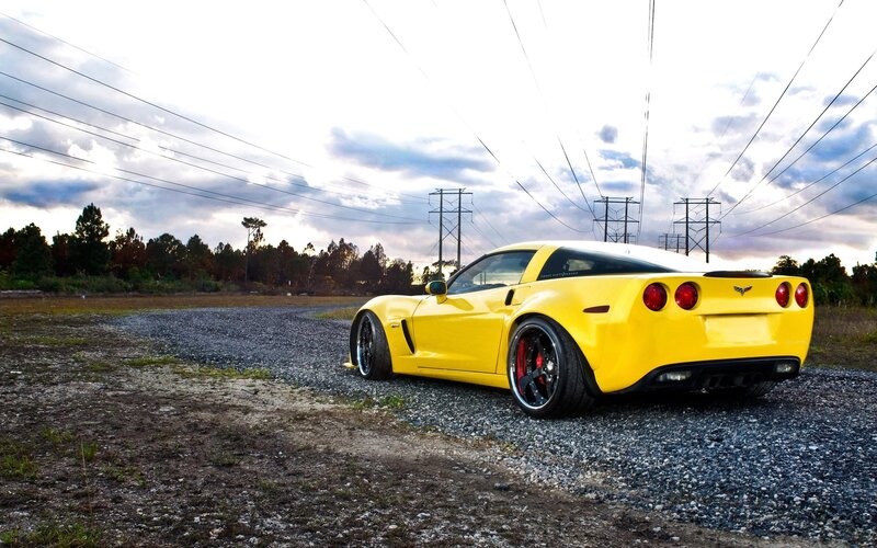 Yellow Corvette on gravel