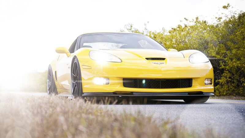 yellow corvette on road