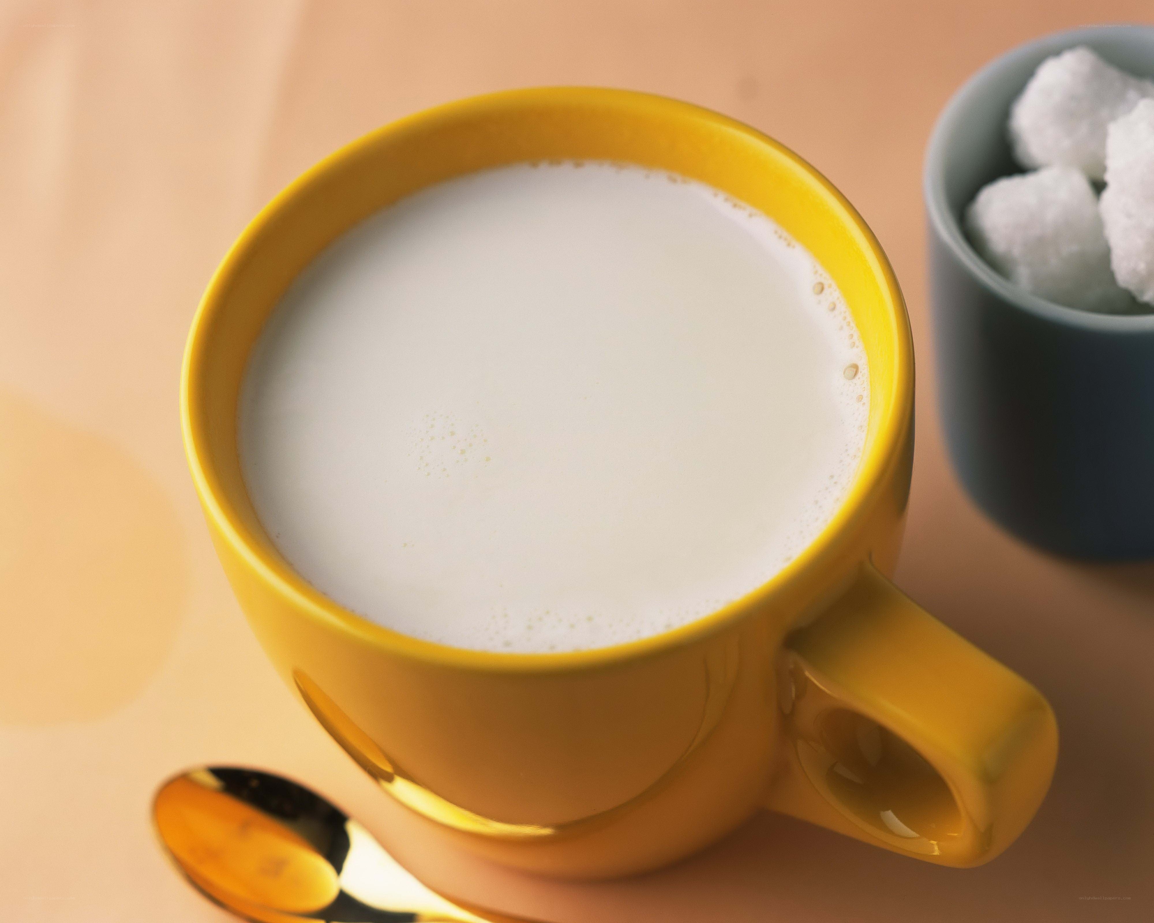 Yellow cup with milk and sugar
