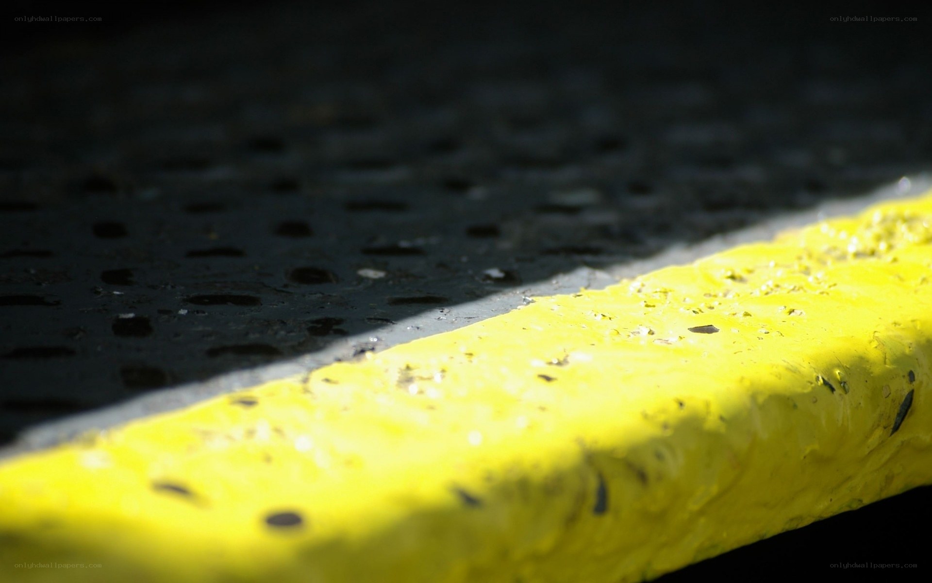 yellow curb and pavement