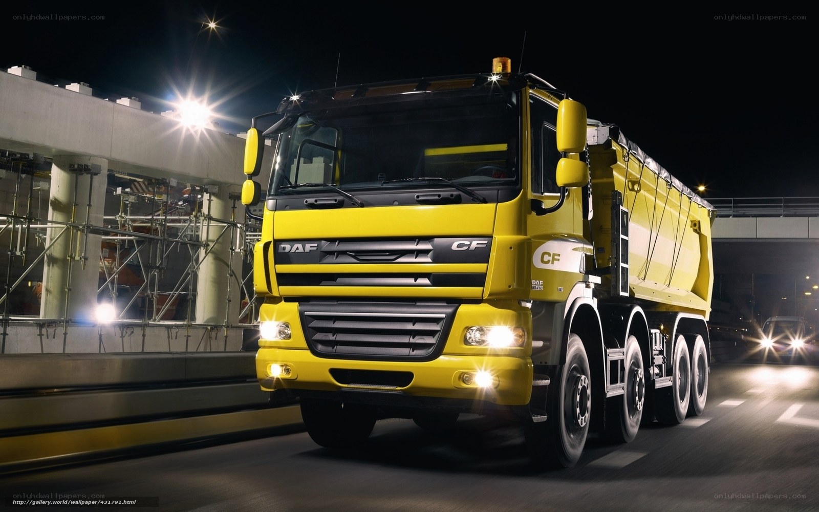 Yellow DAF CF dump truck at night