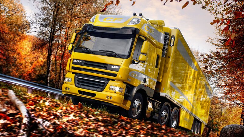 Yellow DAF CF truck on autumn road