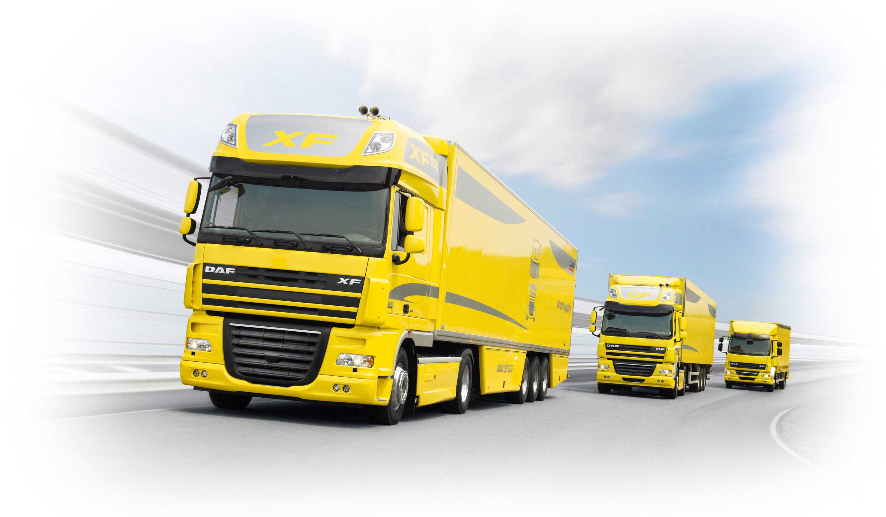 Yellow DAF trucks on the road