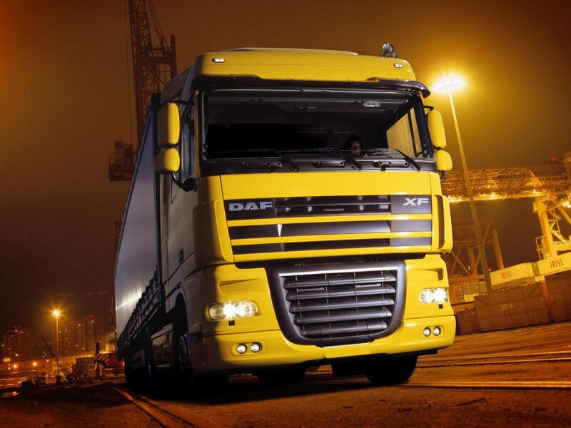 Yellow DAF XF truck at night