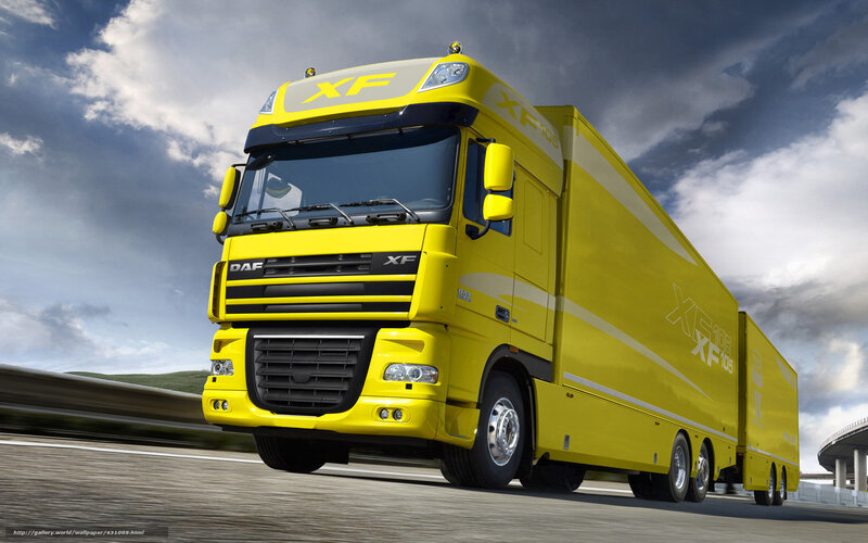 Yellow DAF XF truck on highway