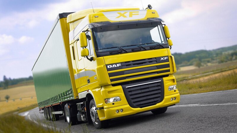Yellow DAF XF truck on road