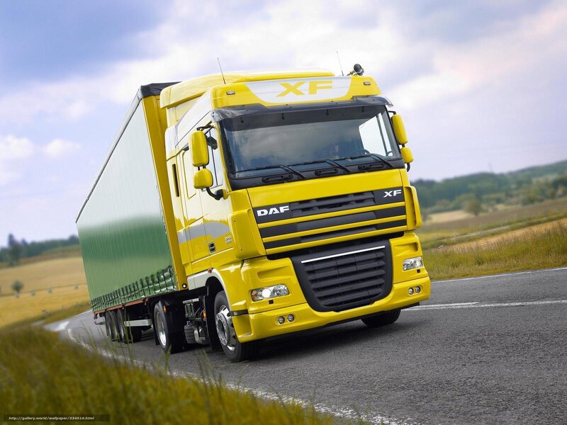 Yellow DAF XF truck on road