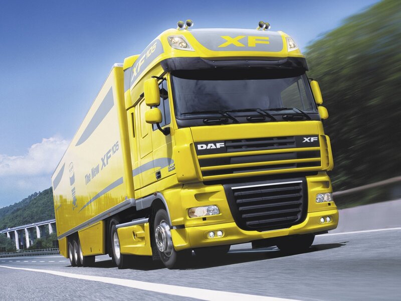 Yellow DAF XF105 truck in motion