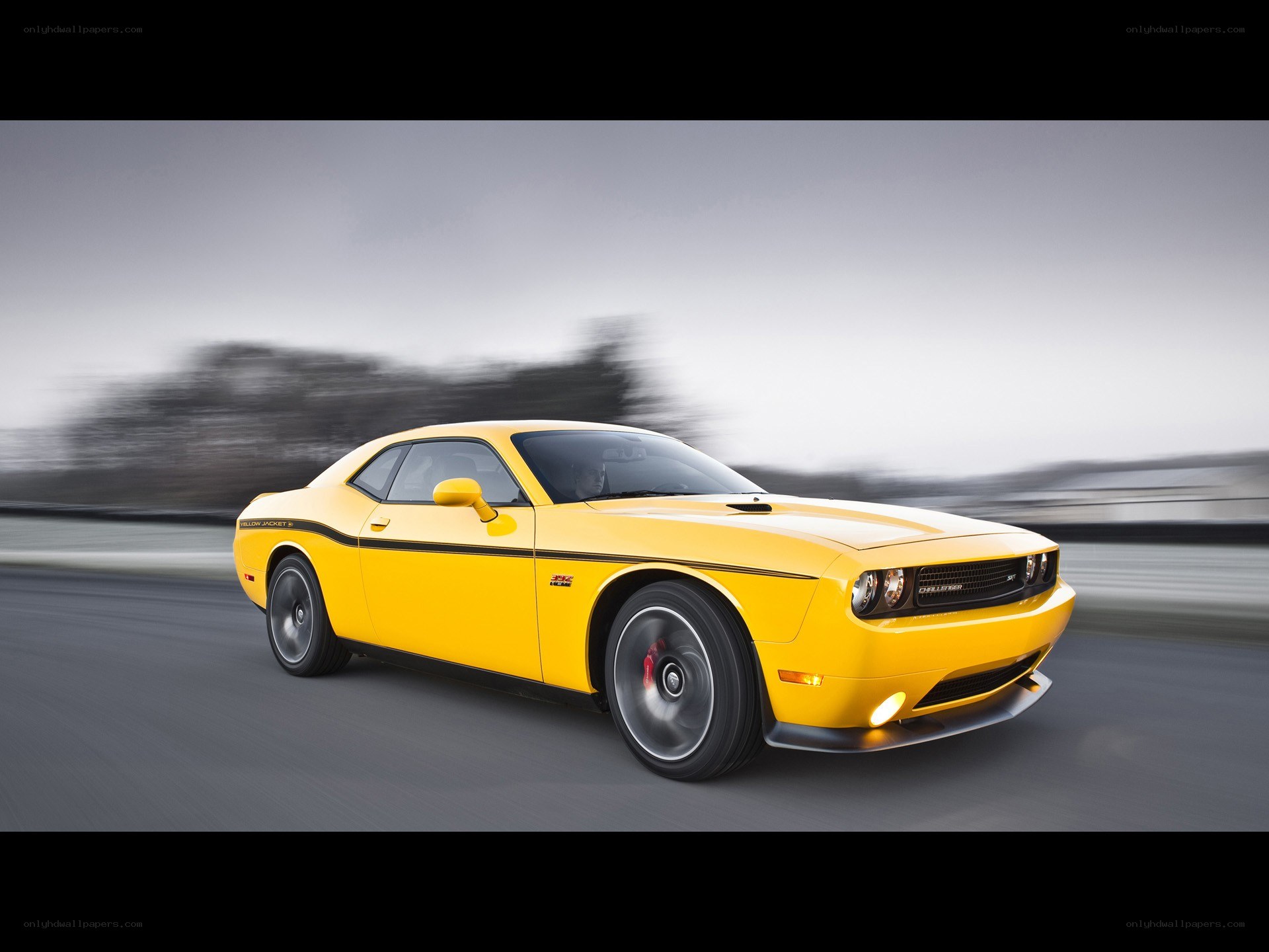 Yellow Dodge Challenger in motion