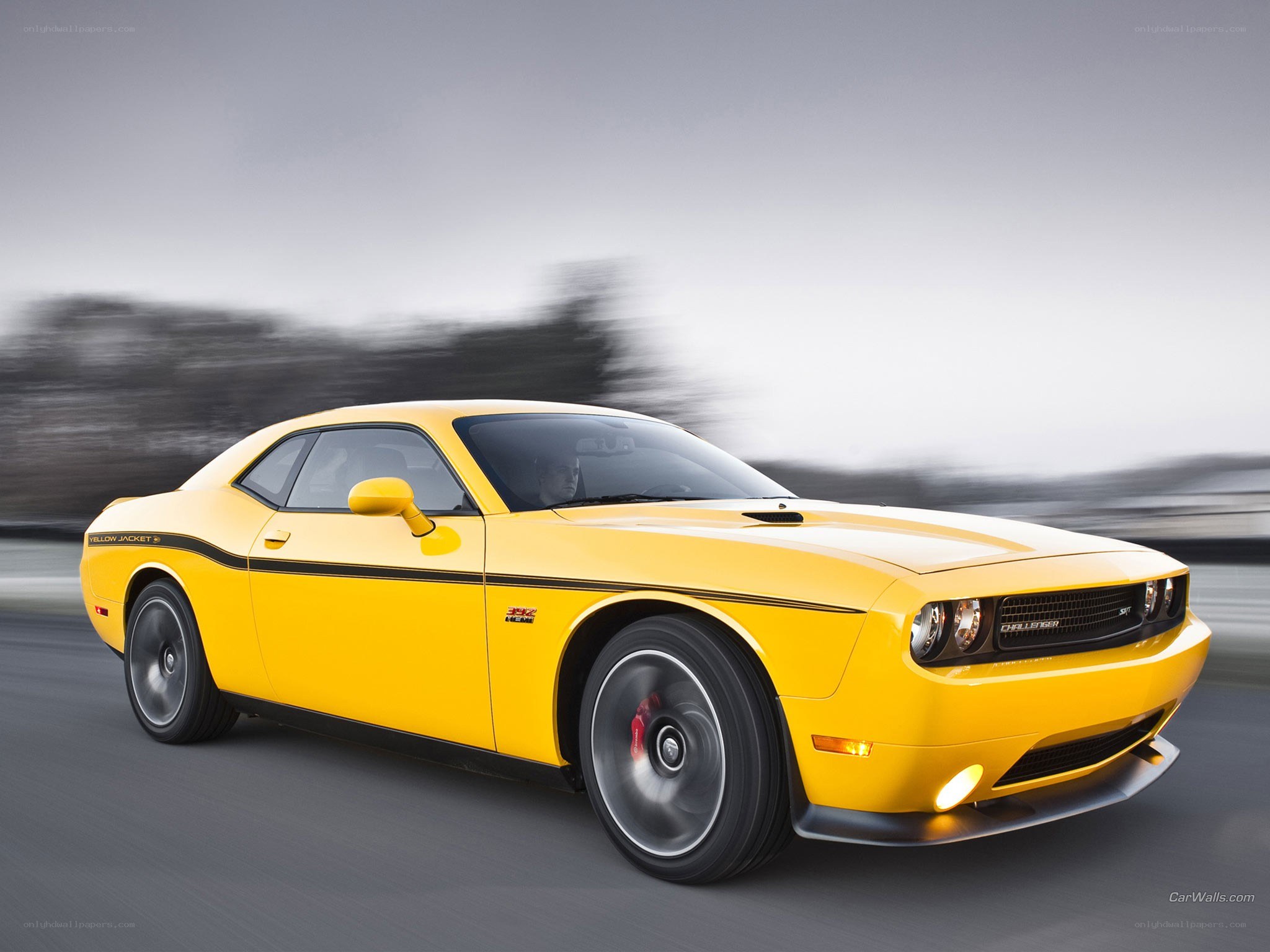 yellow dodge challenger in motion