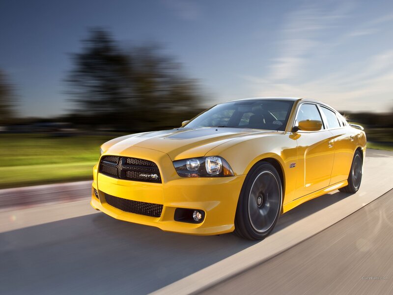 yellow dodge charger in motion