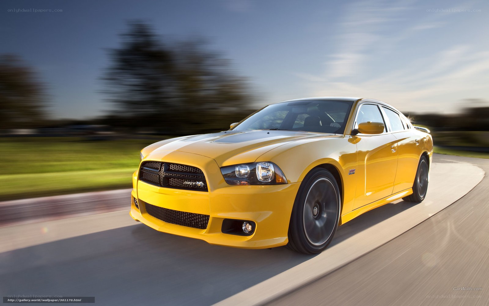 yellow dodge charger in motion