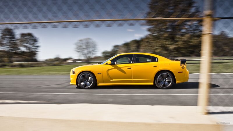 Yellow Dodge Charger on a racetrack