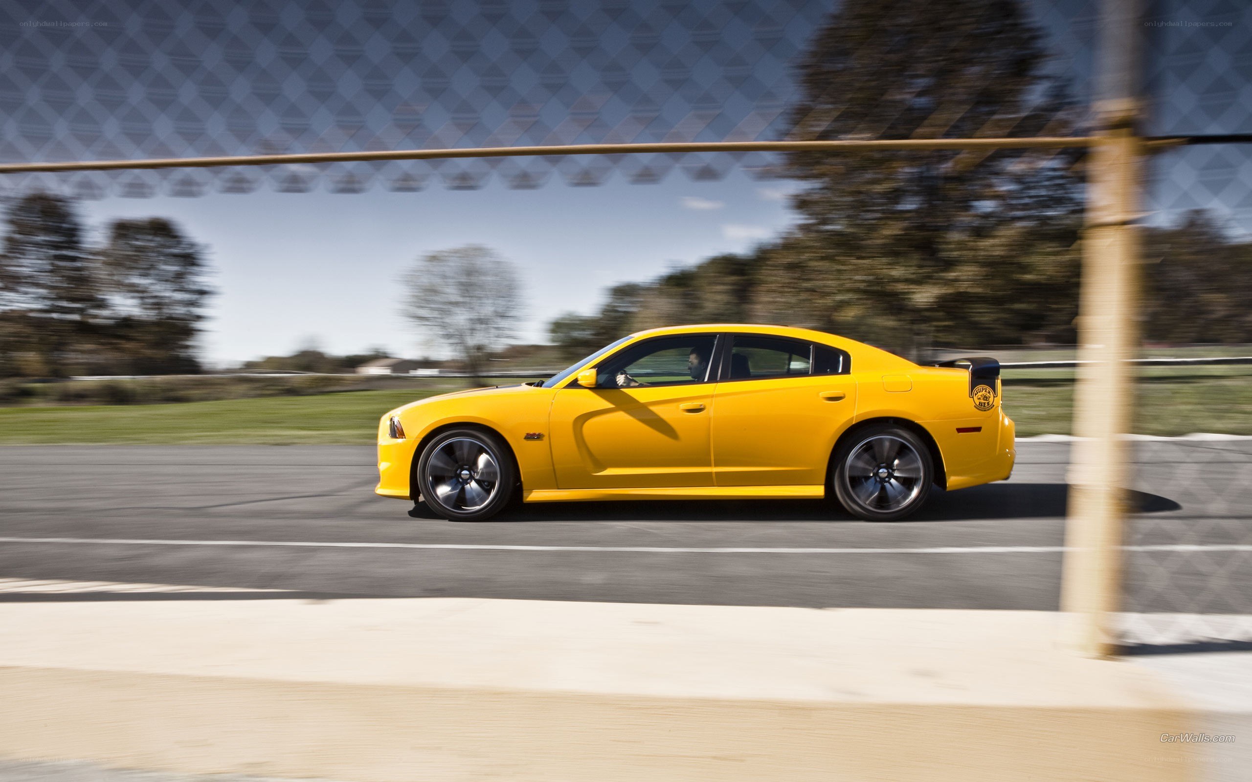 yellow dodge charger on track