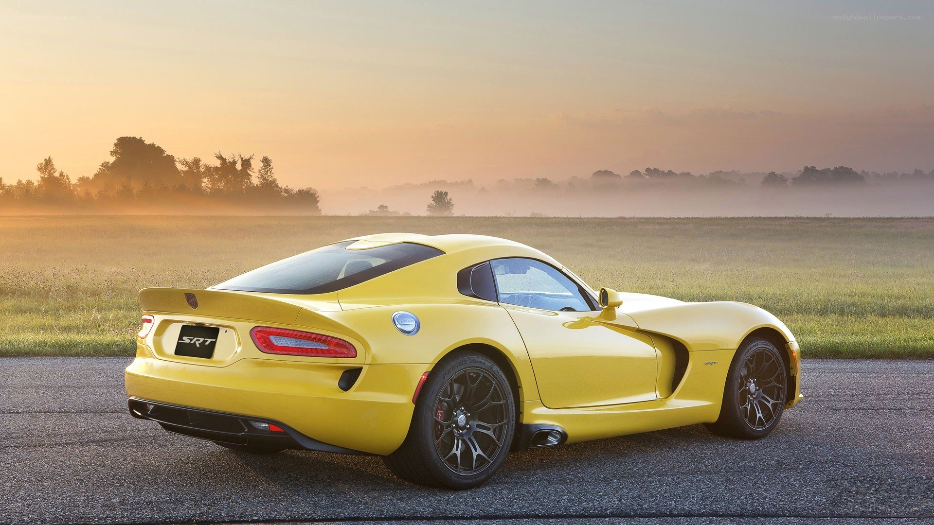 Yellow Dodge Viper SRT on a road