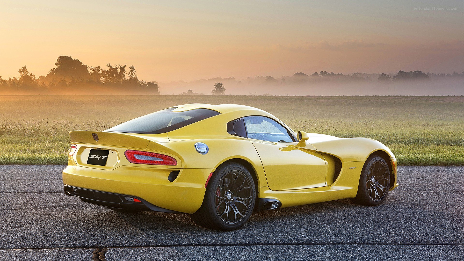 Yellow Dodge Viper SRT on a road