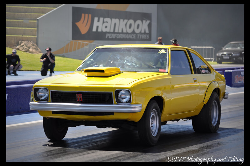Yellow drag racing car on track