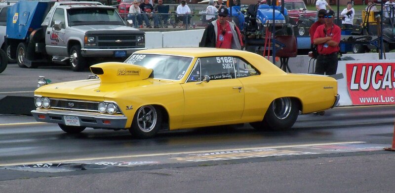 Yellow drag racing car on track