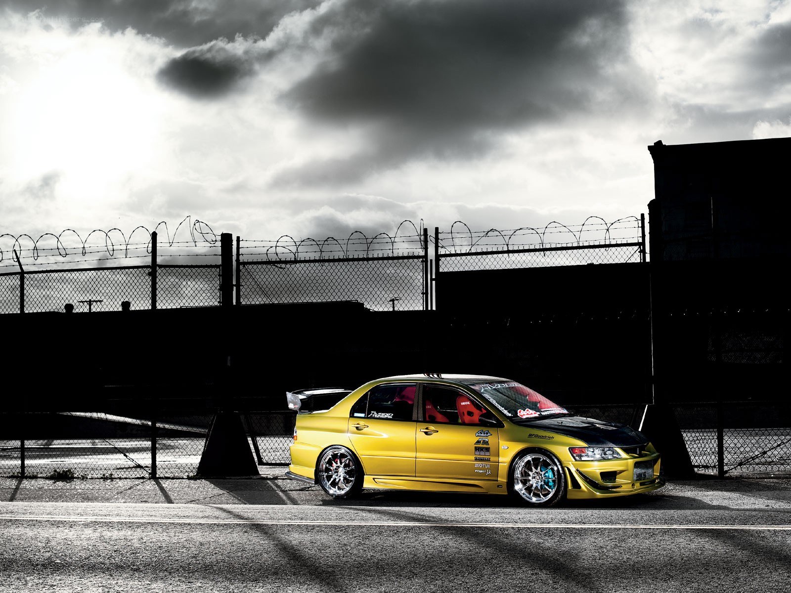Yellow drift car under stormy sky