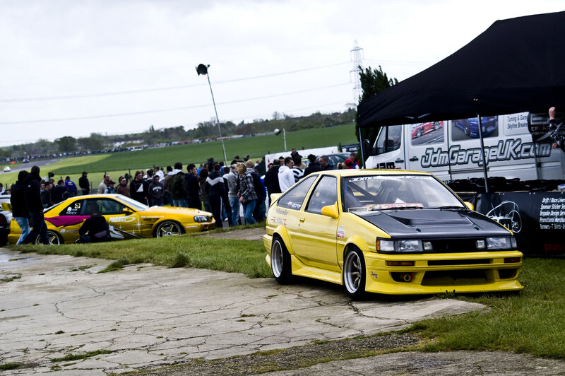 Yellow drift cars at a motorsport event