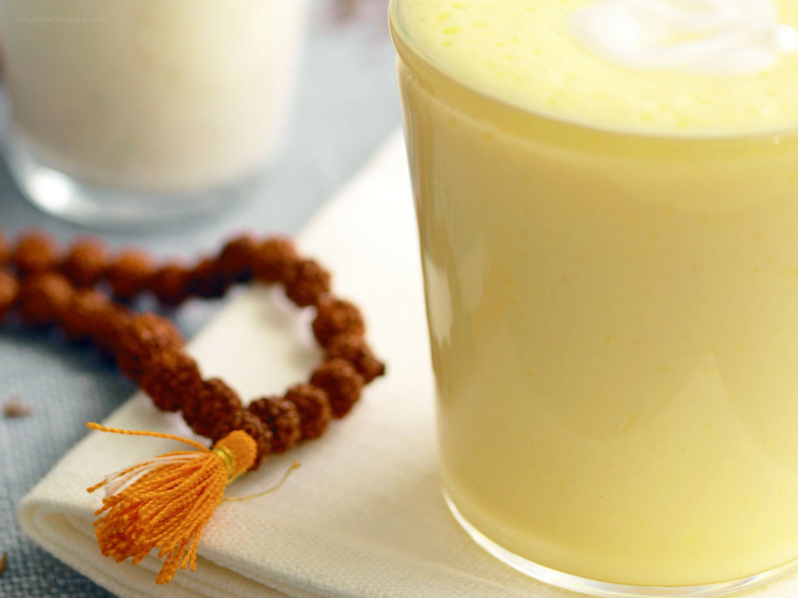 yellow drink with prayer beads