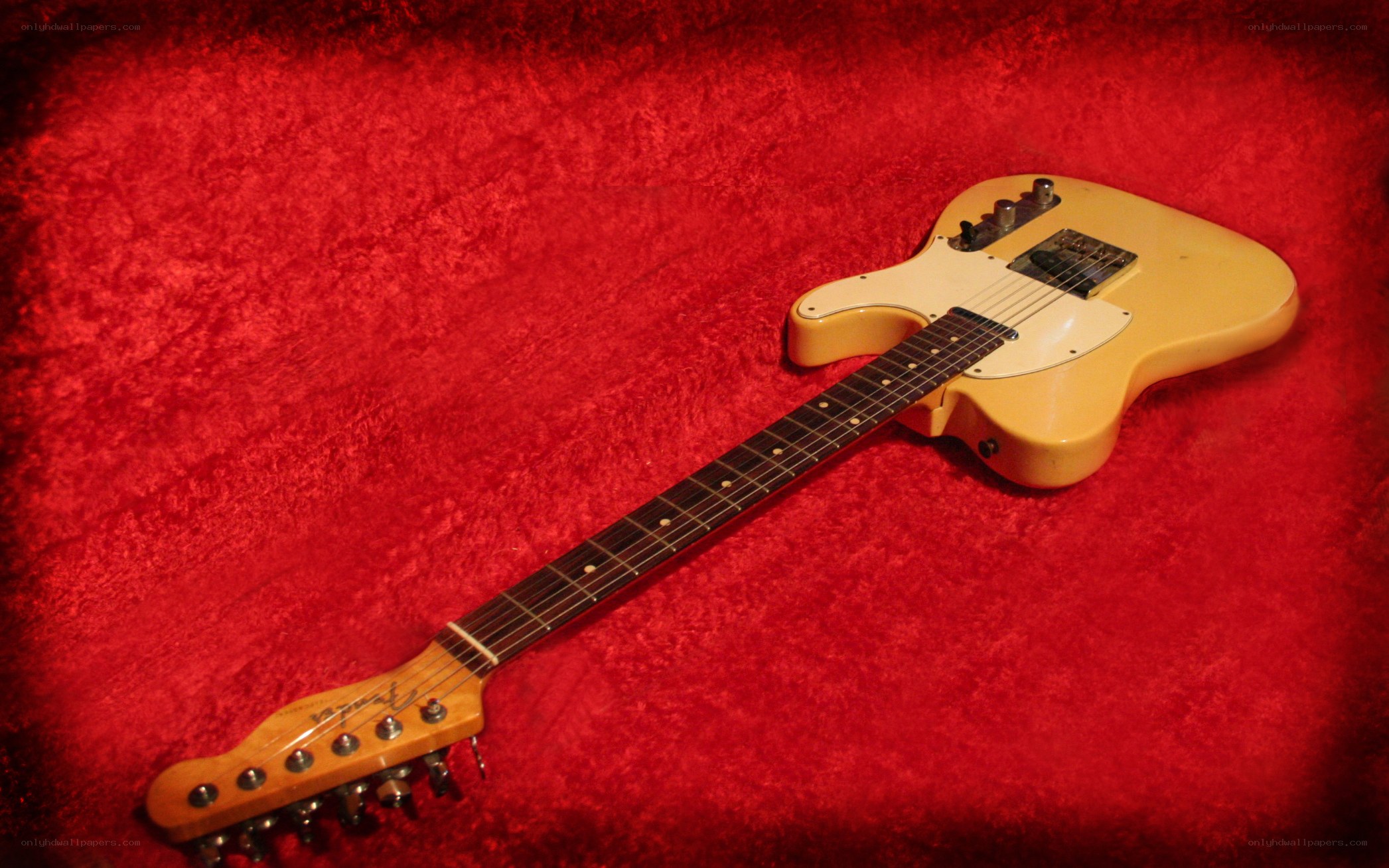 yellow electric guitar on red