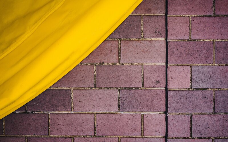 Yellow Fabric on Brick Wall