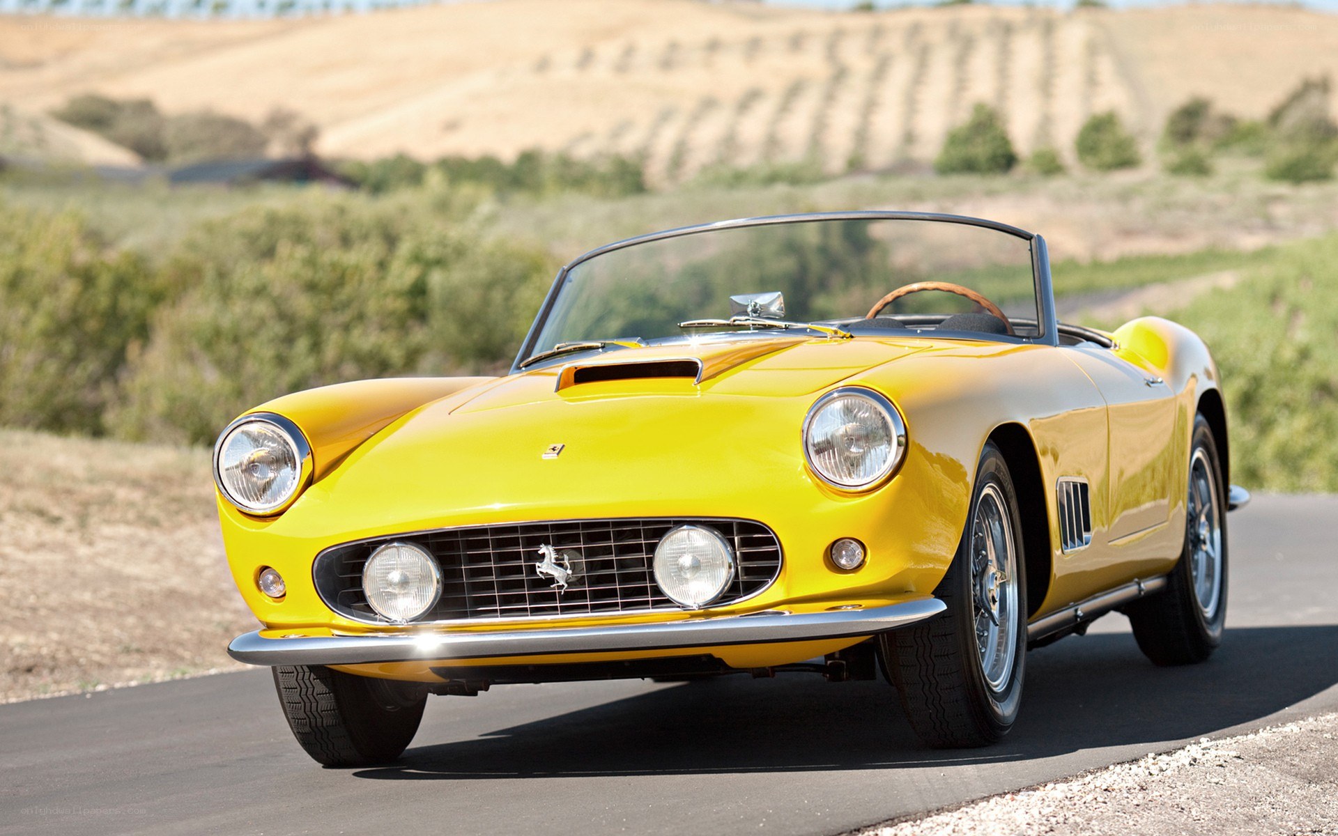 Yellow Ferrari convertible on road