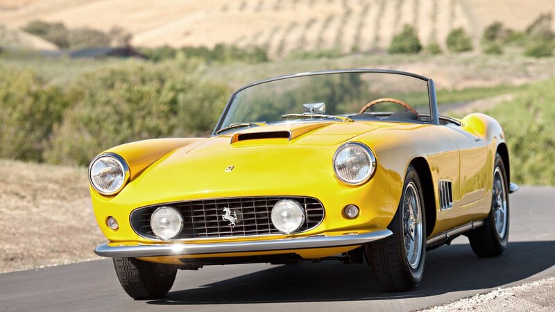 Yellow Ferrari convertible on road